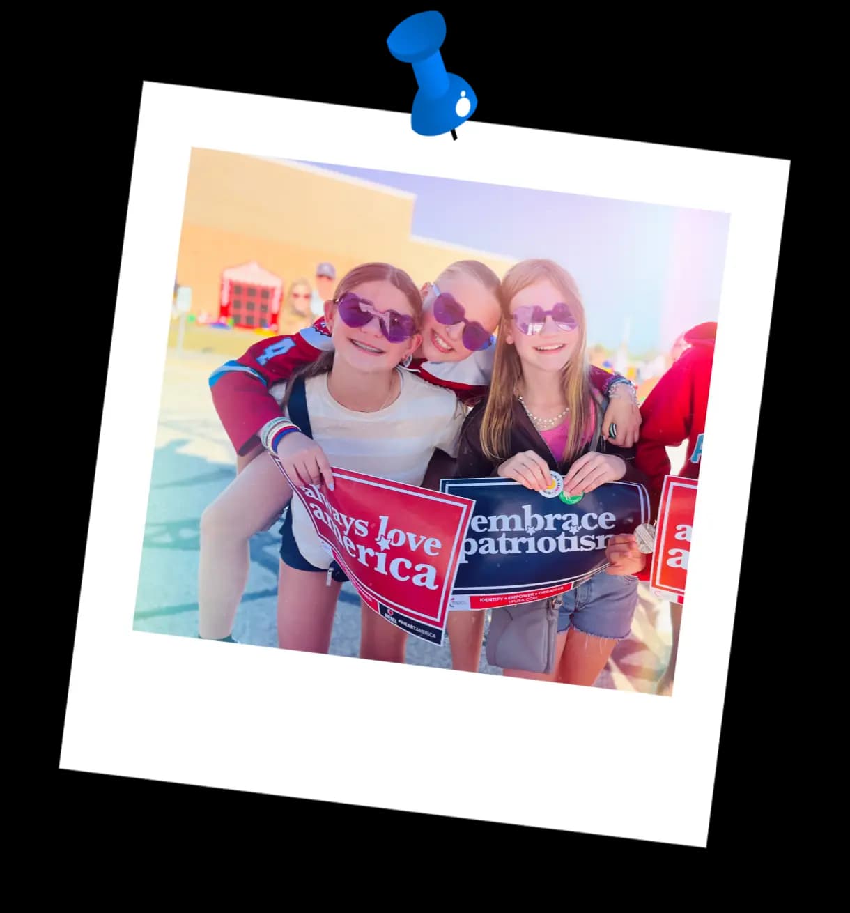 Photograph of students holding Flag the Classroom signs